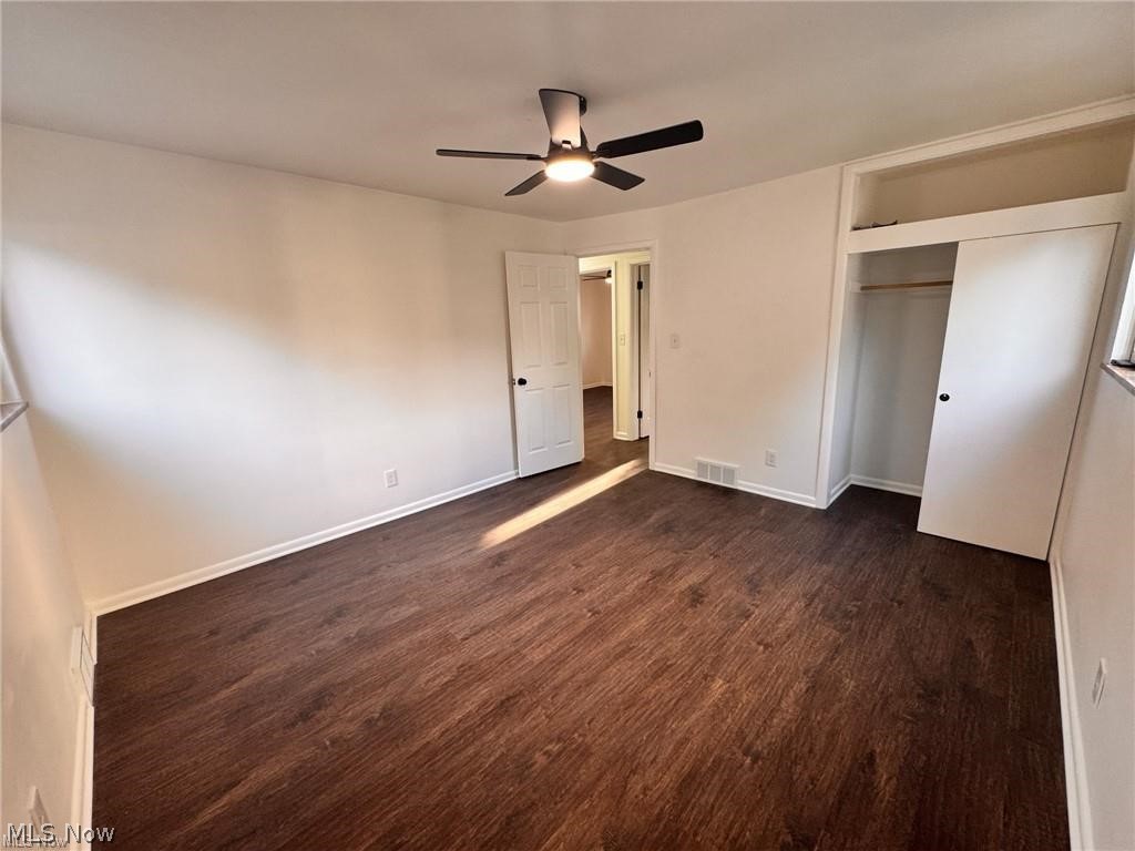 2907 Snow Road, Unit UP Cleveland, OH 44134 - Photo 11 of 19 Unfurnished bedroom featuring ceiling fan, dark wood-style flooring, and a closet