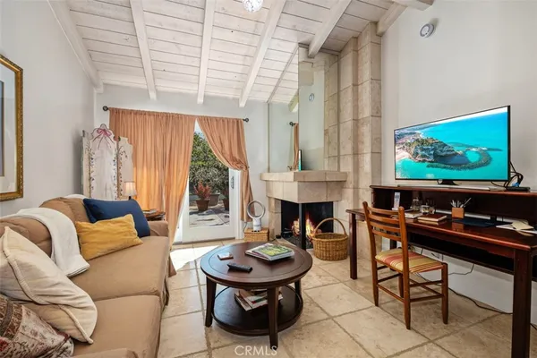 a living room with fireplace furniture and a flat screen tv