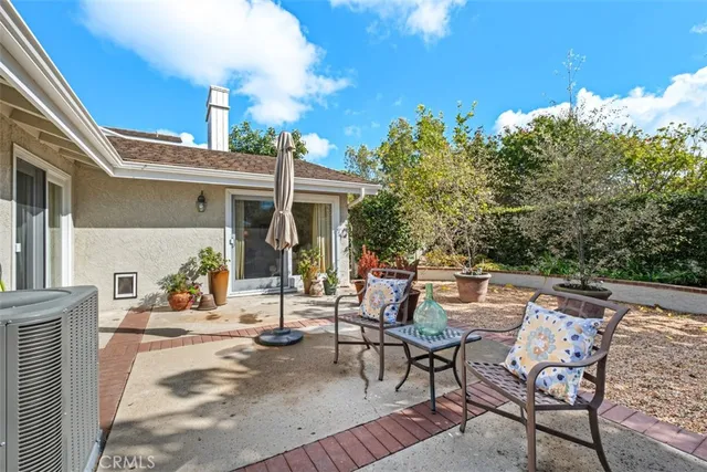 a view of a patio with table and chairs and potted plants