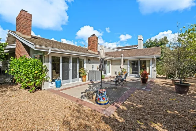 a view of a house with sitting area and garden