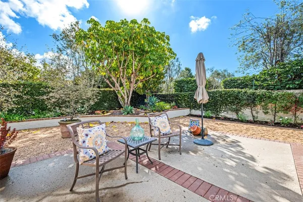 a backyard of a house with table and chairs