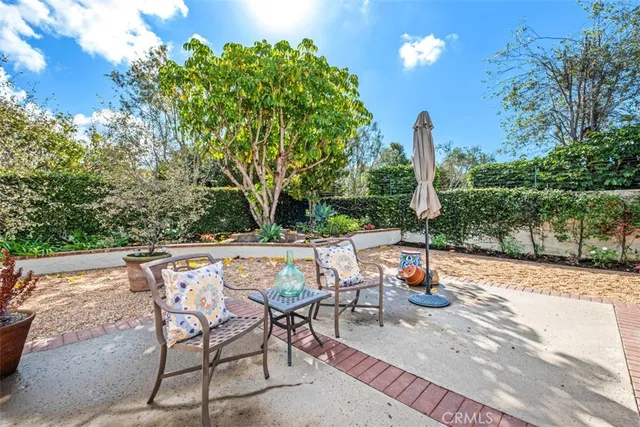 a backyard of a house with table and chairs