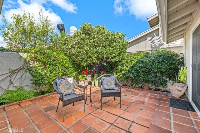 a backyard of a house with table and chairs