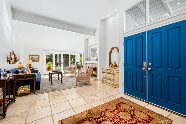 a living room with furniture a piano and a fireplace
