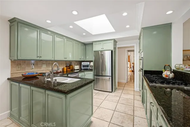 a kitchen with a sink and a stove top oven