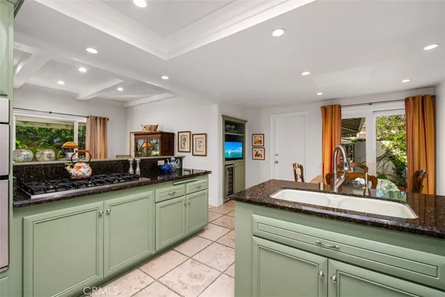 a kitchen with stainless steel appliances kitchen island granite countertop a sink and cabinets