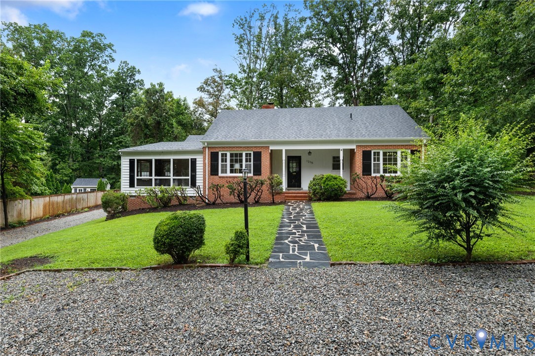 a house that has a tree in front of a house