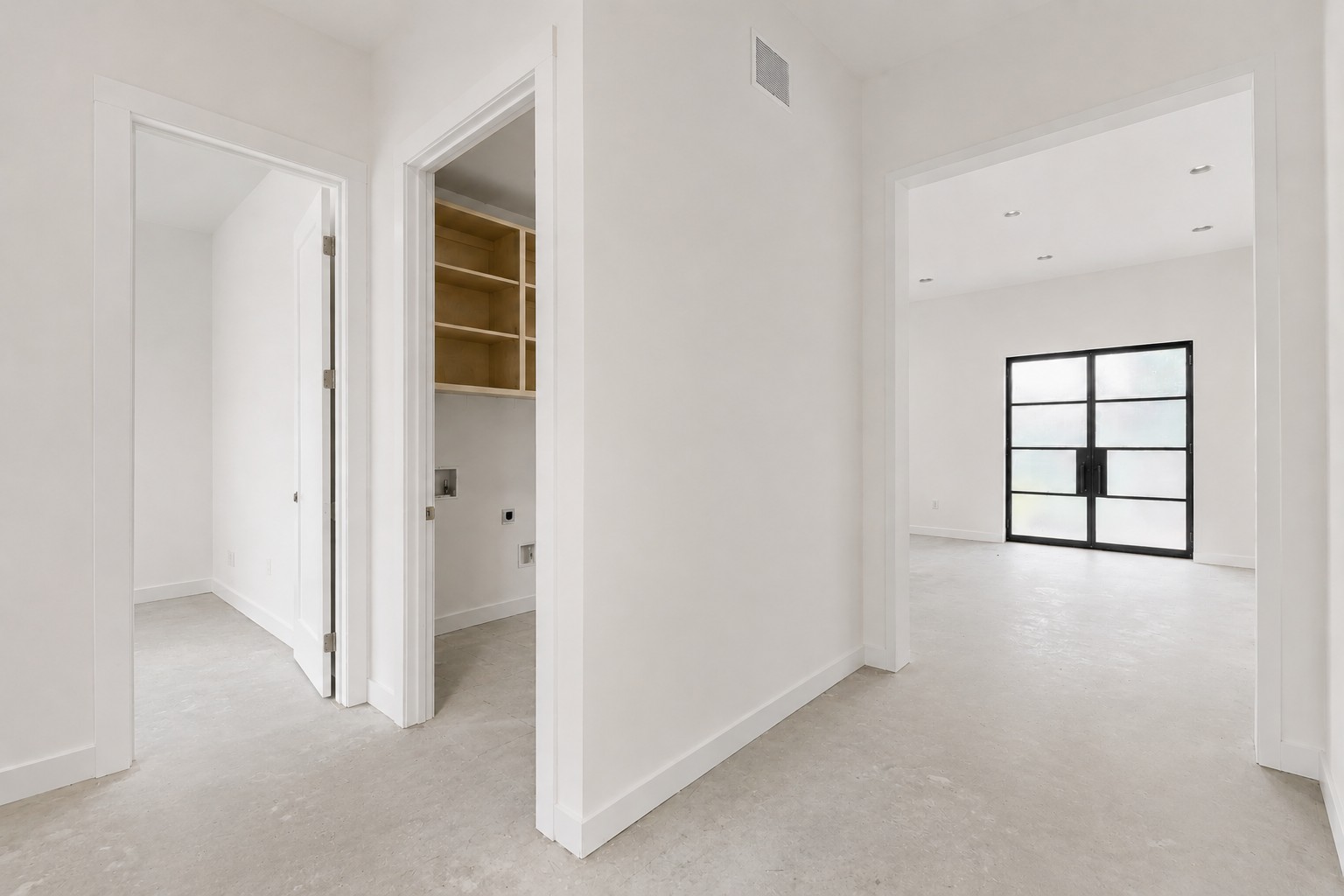 4603 Bucks Run Austin, TX 78744 - Photo 8 of 14 Expansive entryway with light-toned flooring, leading to a room with a large black-framed glass door