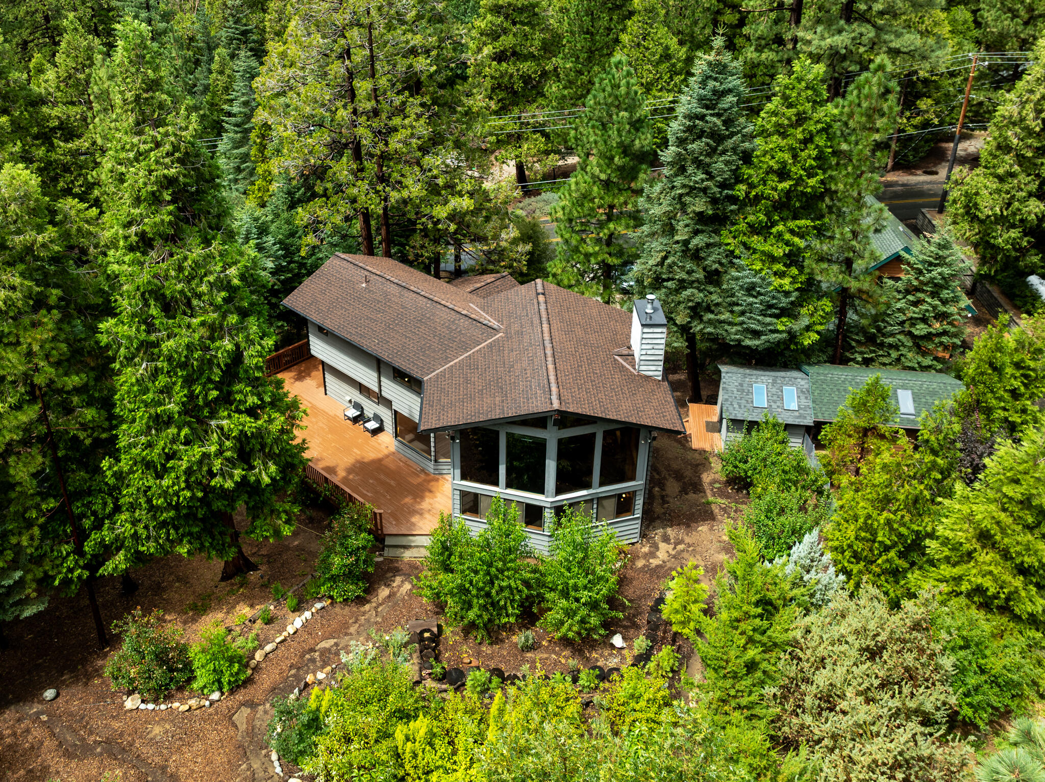 an aerial view of a house with a yard and large trees