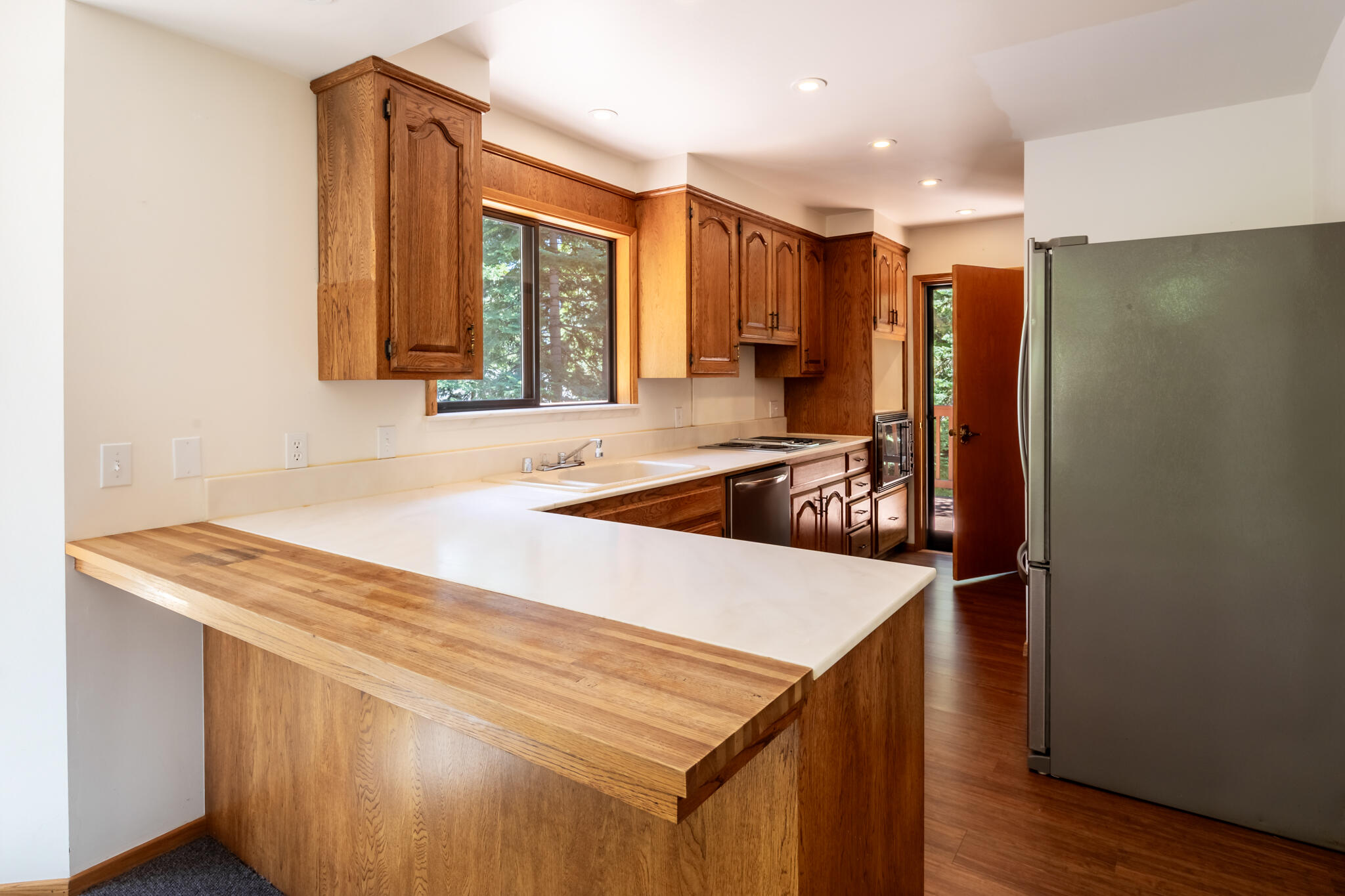 24752 Fern Valley Road Idyllwild, CA 92549 - Photo 18 of 35 a kitchen with a sink a refrigerator and wooden floor