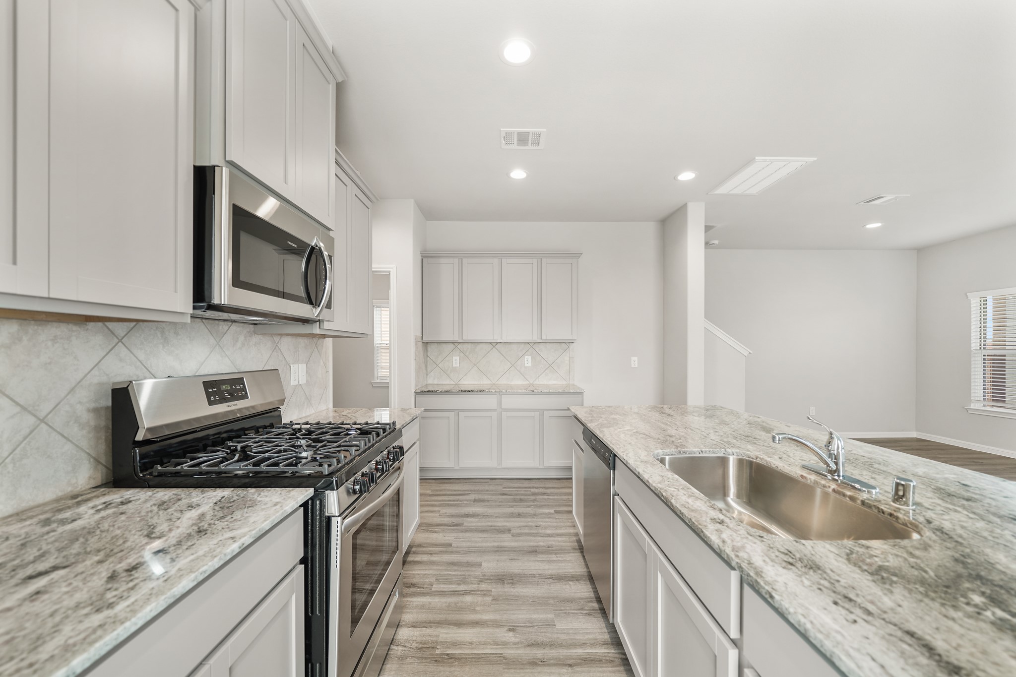 13313 Talisker Road Houston, TX 77048 - Photo 2 of 11 a kitchen with a sink stove top oven and microwave