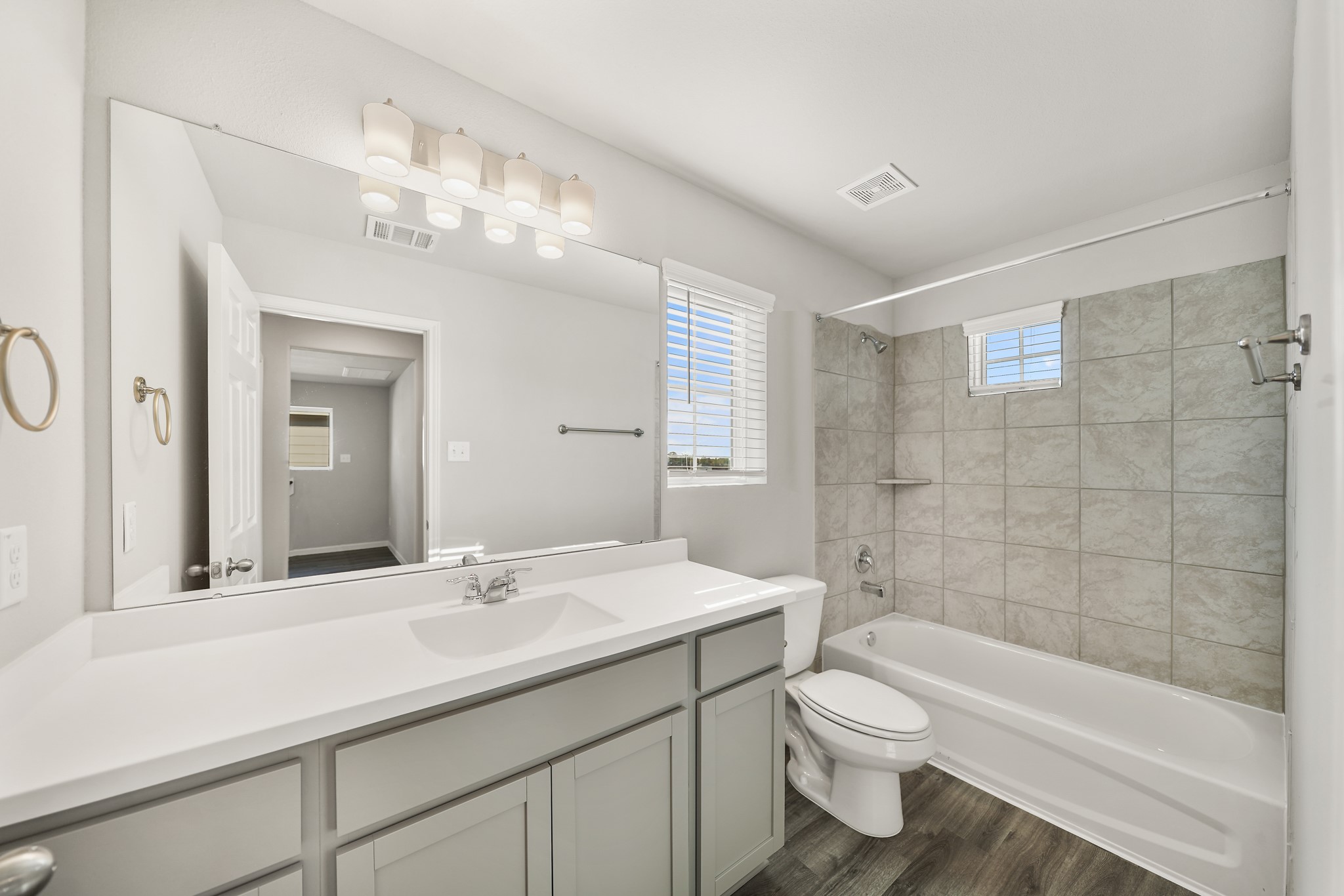 13313 Talisker Road Houston, TX 77048 - Photo 7 of 11 a bathroom with a toilet a sink a bathtub and a mirror