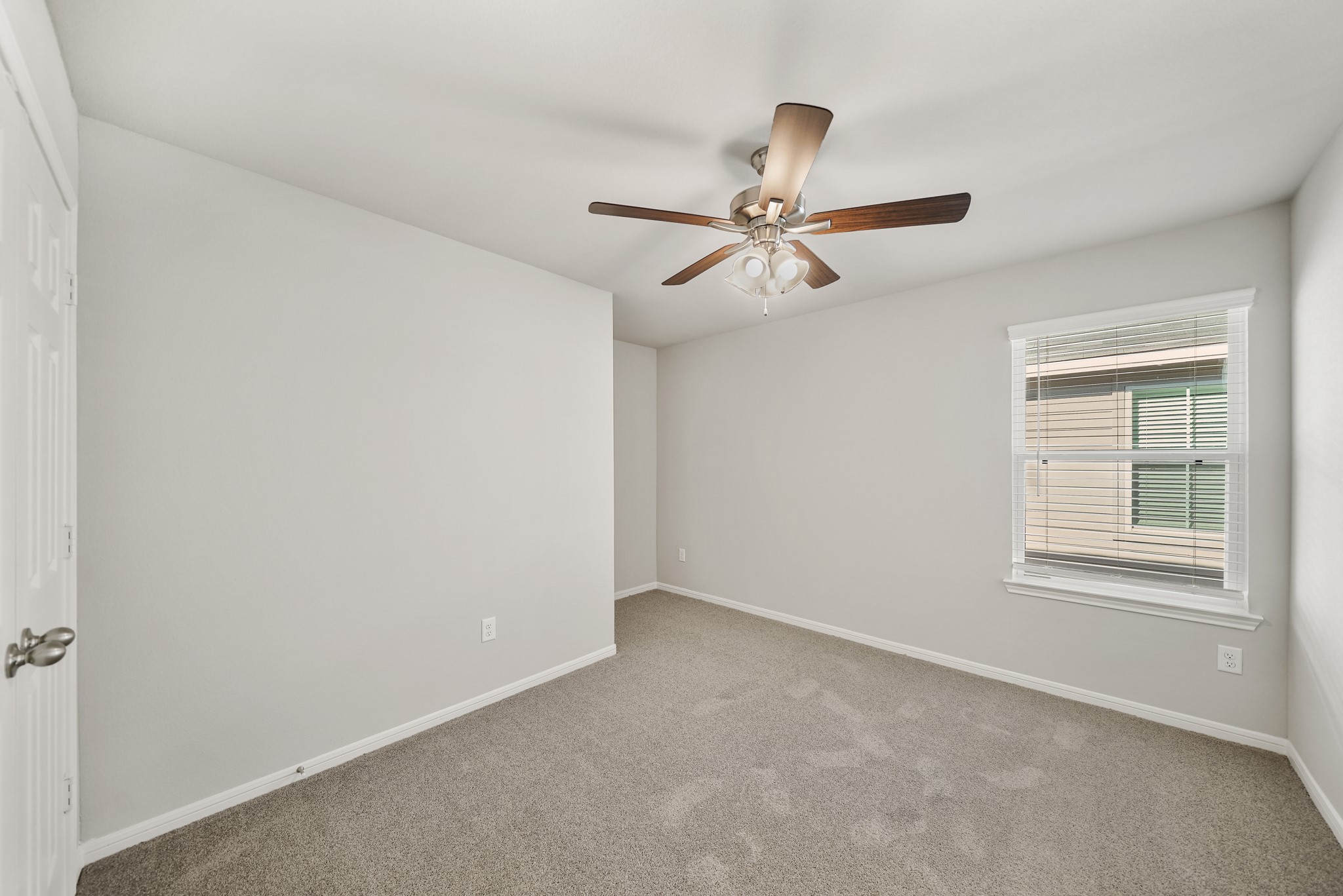 13313 Talisker Road Houston, TX 77048 - Photo 8 of 11 an empty room with a window and a fan