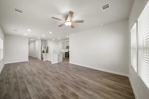 a view of a kitchen with wooden floor and a window