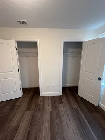 a view of a room with wooden floor