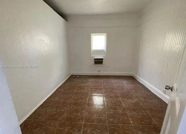 an empty room with a empty space and windows
