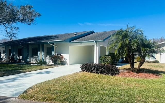 2033 Hawkhurst Circle, Unit 180 Sun City Center, FL 33573 - Photo 16 of 19 a front view of a house with garden