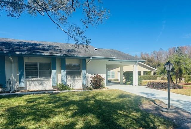 2033 Hawkhurst Circle, Unit 180 Sun City Center, FL 33573 - Photo 3 of 19 a front view of a house with a garden