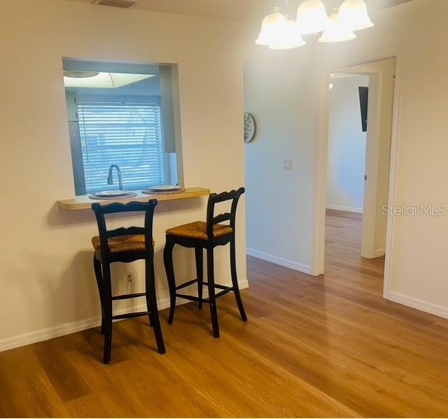 2033 Hawkhurst Circle, Unit 180 Sun City Center, FL 33573 - Photo 9 of 19 a view of a room with furniture and wooden floor