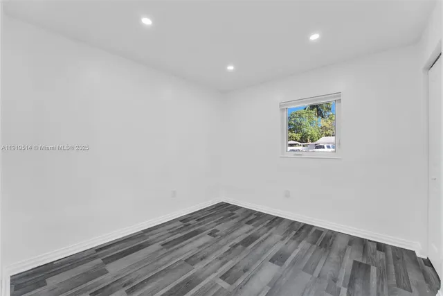a view of room with wooden floor and window