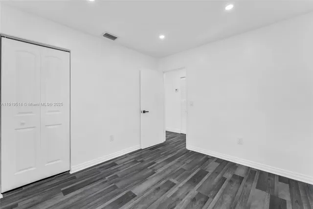 a view of a room with wooden floor