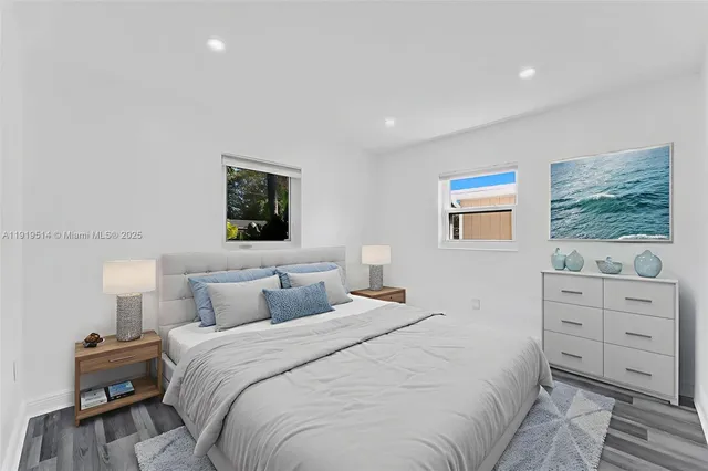 a bedroom with a bed and a night stand