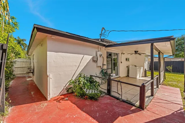 a view of a porch with furniture and garden