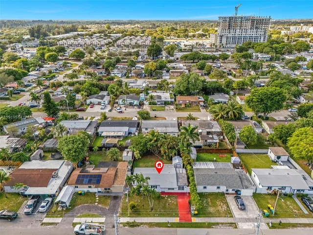 an aerial view of residential houses and lake