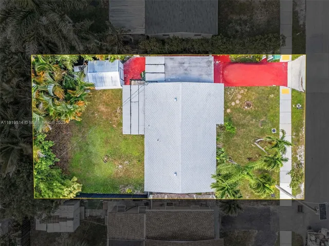an aerial view of residential house with outdoor space and trees