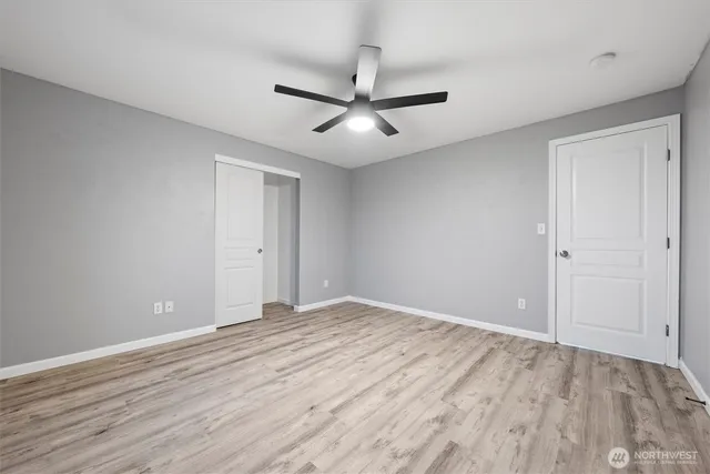 a view of empty room with wooden floor