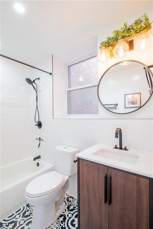 10104 4th Avenue, Unit 2B Brooklyn, NY 11209 - Photo 11 of 27 a bathroom with a sink a toilet and a mirror