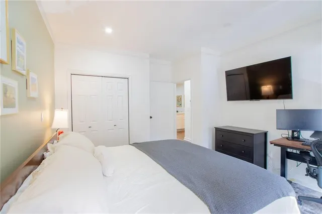 a bedroom with a bed and a flat screen tv