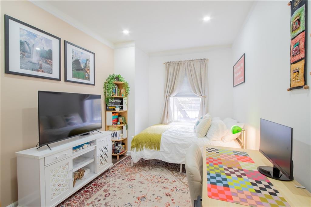 10104 4th Avenue, Unit 2B Brooklyn, NY 11209 - Photo 15 of 27 a bedroom with a bed and a flat screen tv