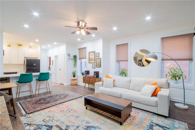 a living room with furniture and wooden floor