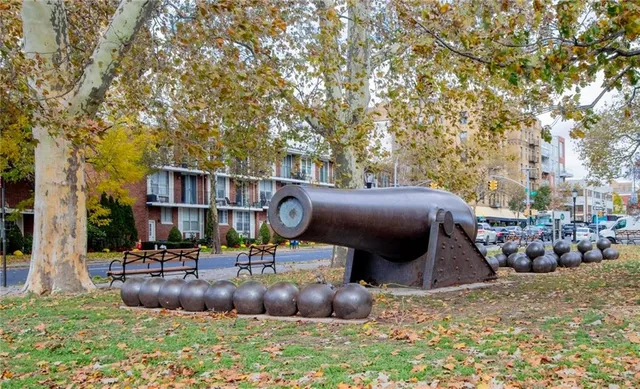 a front view of a residential apartment building with a yard