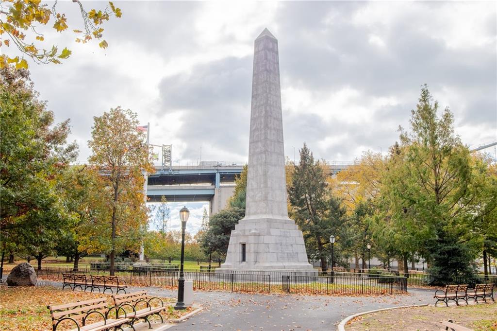 10104 4th Avenue, Unit 2B Brooklyn, NY 11209 - Photo 26 of 27 a front view of a residential apartment building with a yard