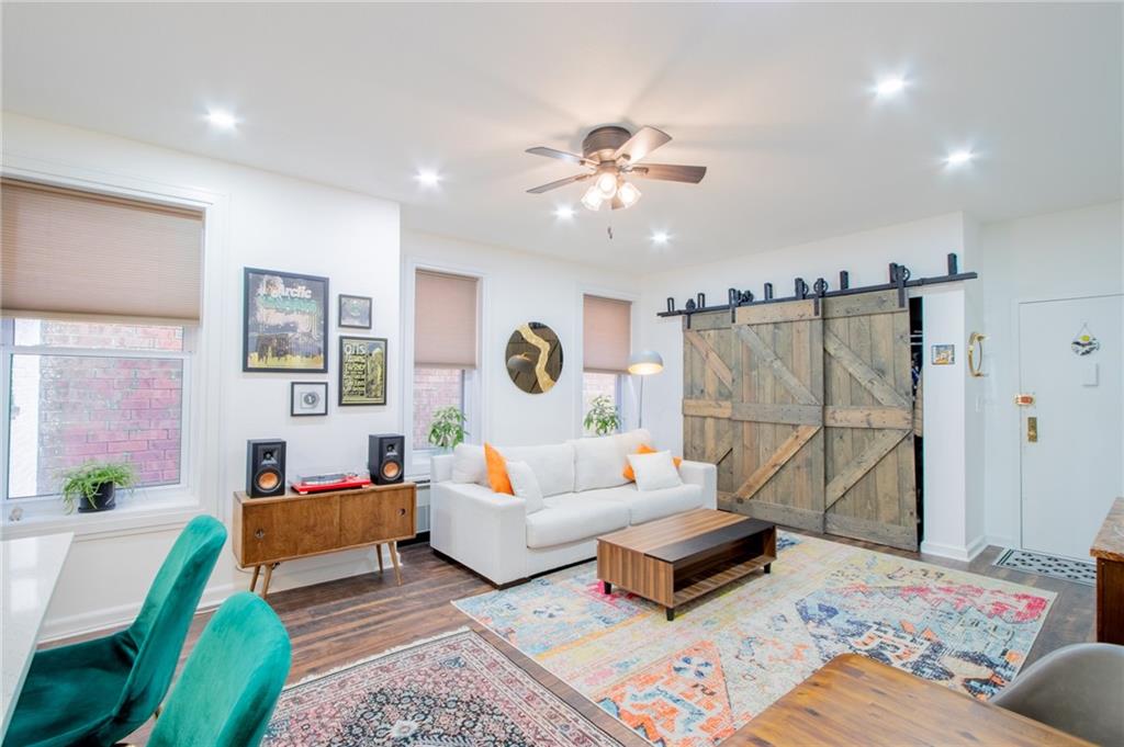 10104 4th Avenue, Unit 2B Brooklyn, NY 11209 - Photo 7 of 27 a living room with furniture and a flat screen tv