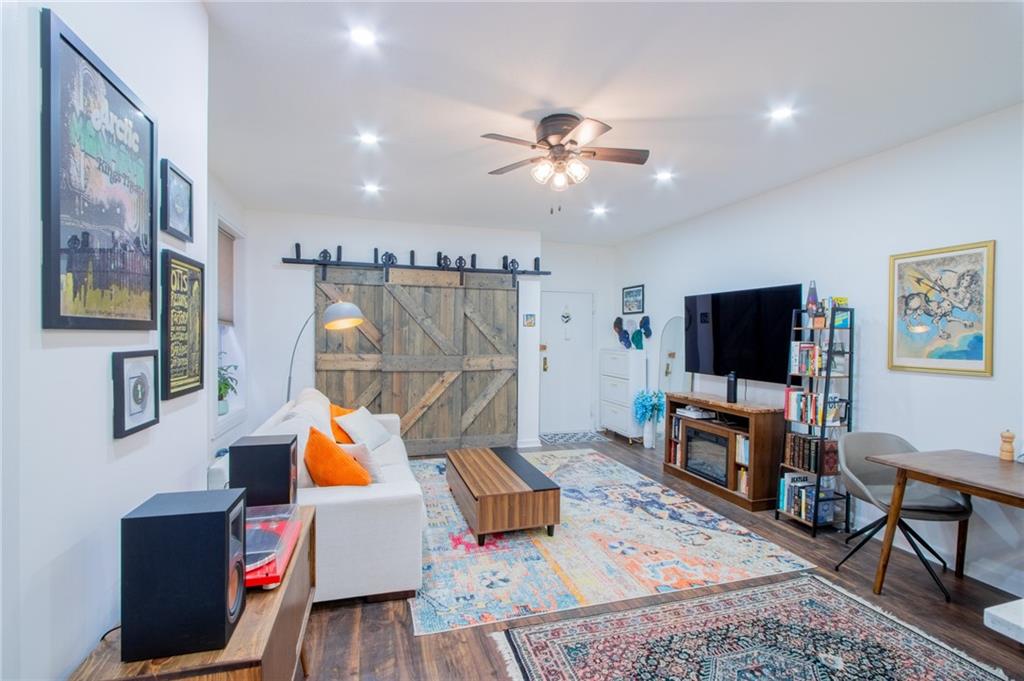 10104 4th Avenue, Unit 2B Brooklyn, NY 11209 - Photo 9 of 27 a living room with furniture and a flat screen tv
