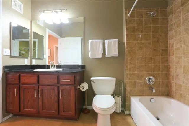 a bathroom with a sink a toilet and bathtub