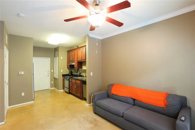 a living room with a couch and a ceiling fan