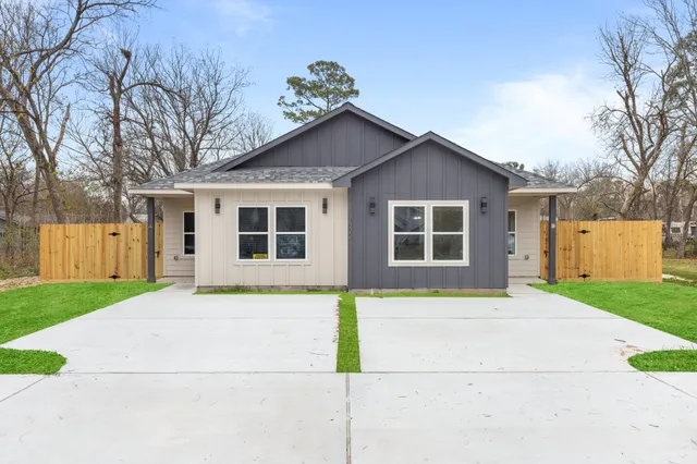 a house that has a large tree in front of it