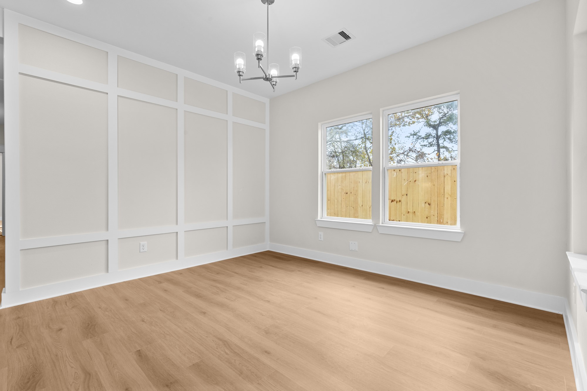 7322 Phillips Street Houston, TX 77088 - Photo 13 of 27 an empty room with chandelier fan and windows