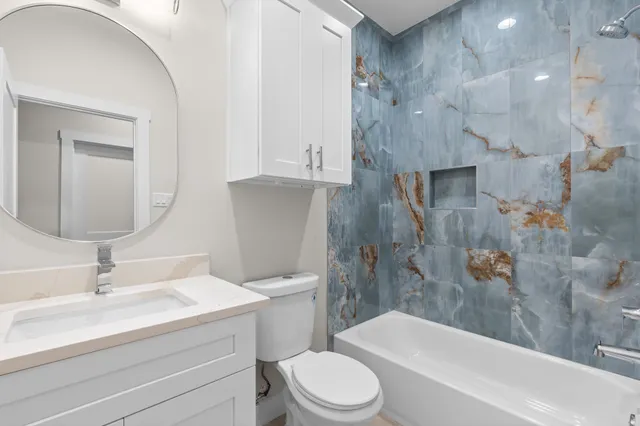 a bathroom with a sink toilet and shower