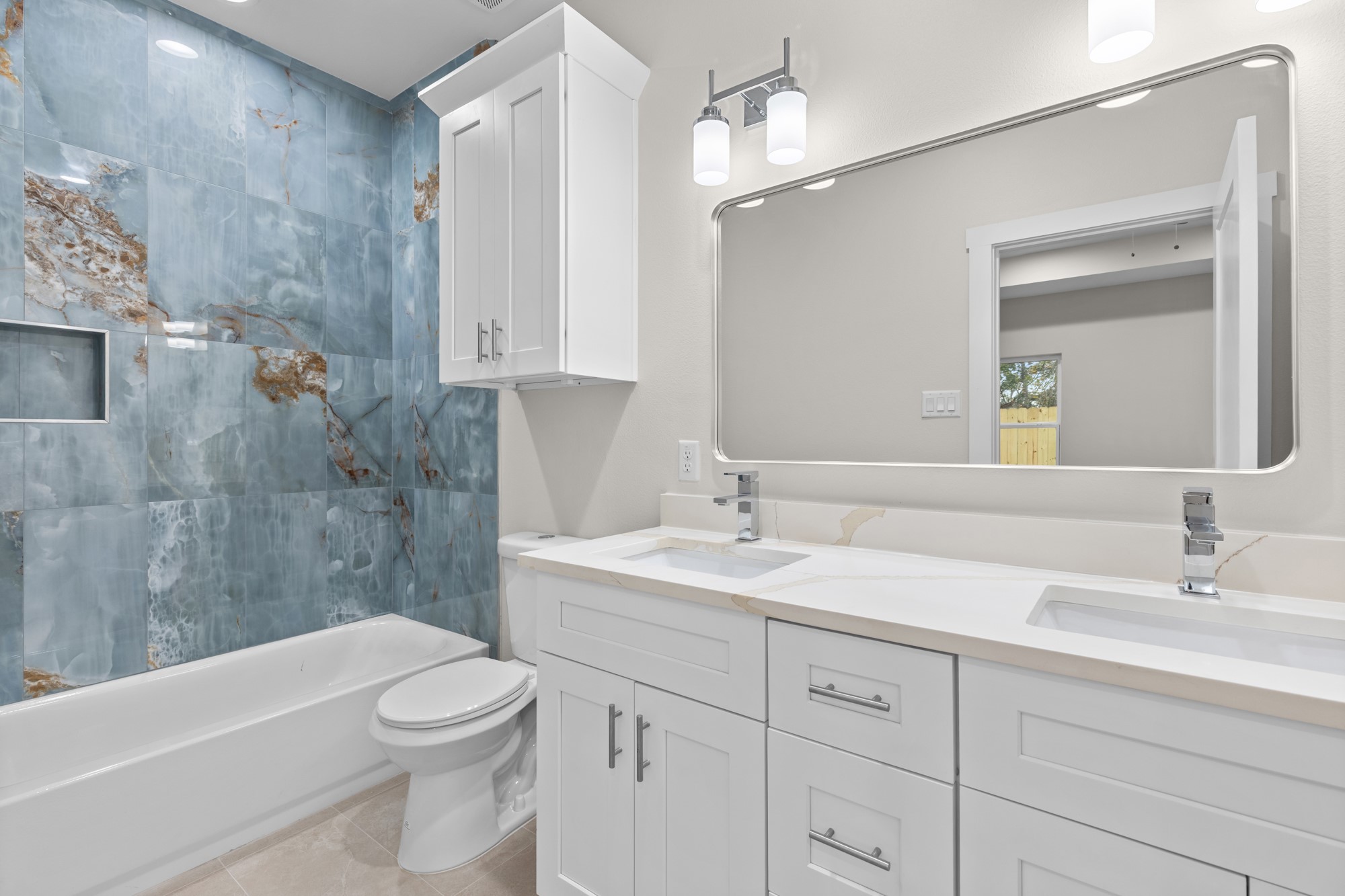 7322 Phillips Street Houston, TX 77088 - Photo 23 of 27 a bathroom with a toilet a sink a bathtub a mirror and vanity