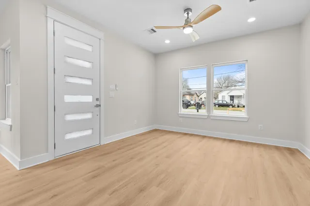 wooden floor in an empty room with a window