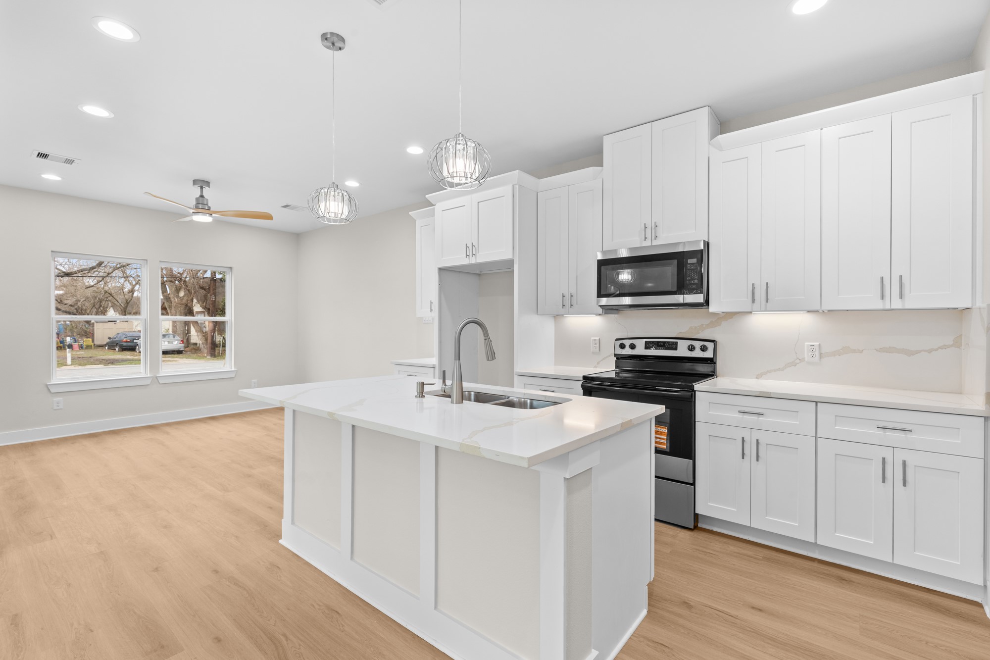 7322 Phillips Street Houston, TX 77088 - Photo 6 of 27 a kitchen with stainless steel appliances granite countertop a sink dishwasher a stove and a refrigerator with wooden floor