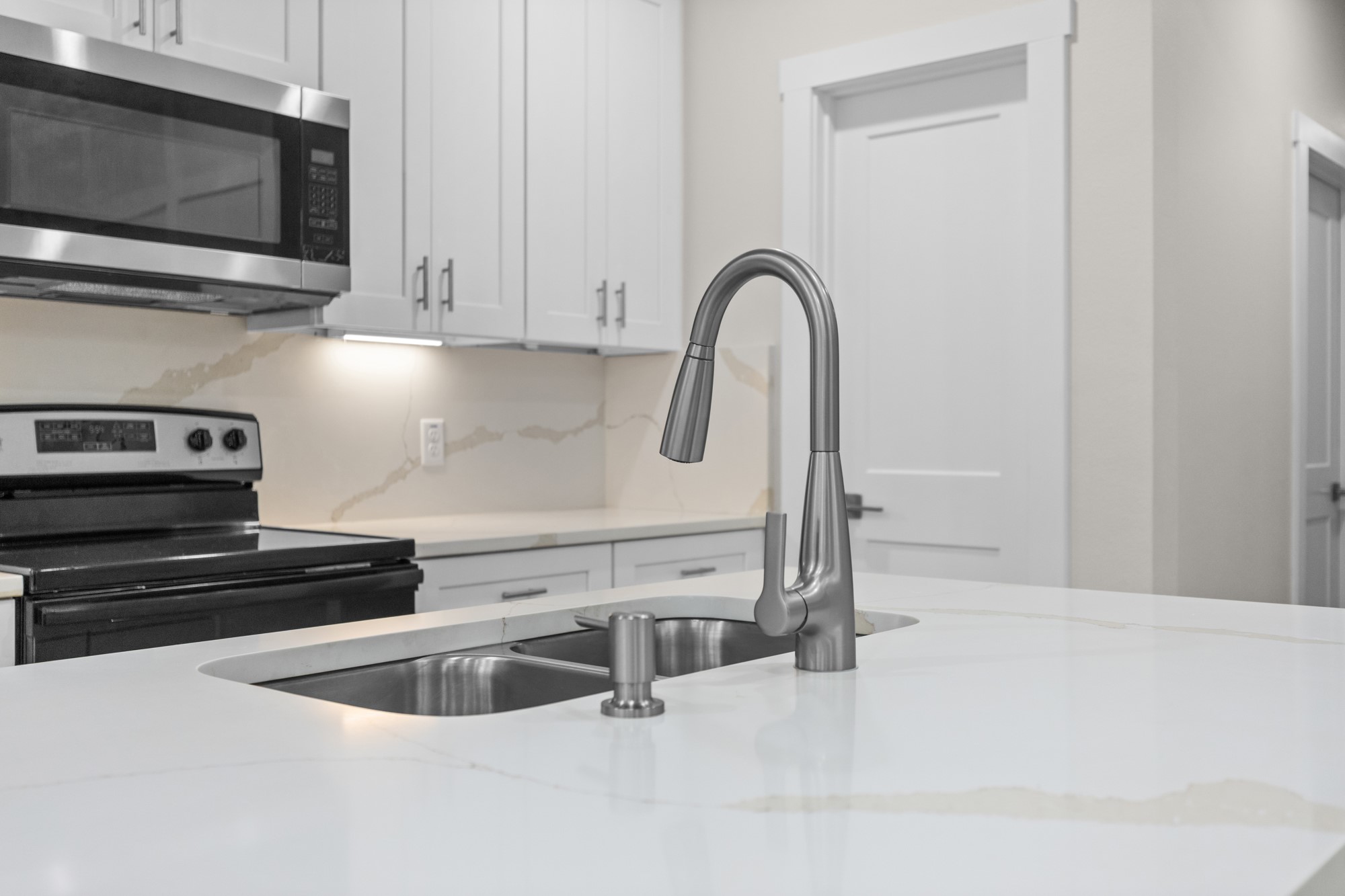 7322 Phillips Street Houston, TX 77088 - Photo 10 of 27 a kitchen with stainless steel appliances granite countertop a sink a microwave and cabinets