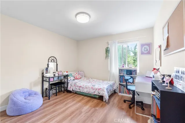 a bedroom with furniture and a wooden floor