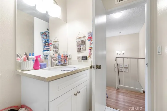 a bathroom with a sink vanity and a mirror