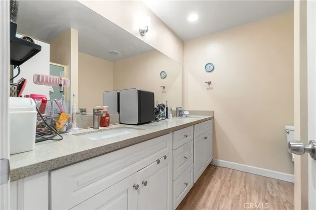a bathroom with a double vanity sink and mirror
